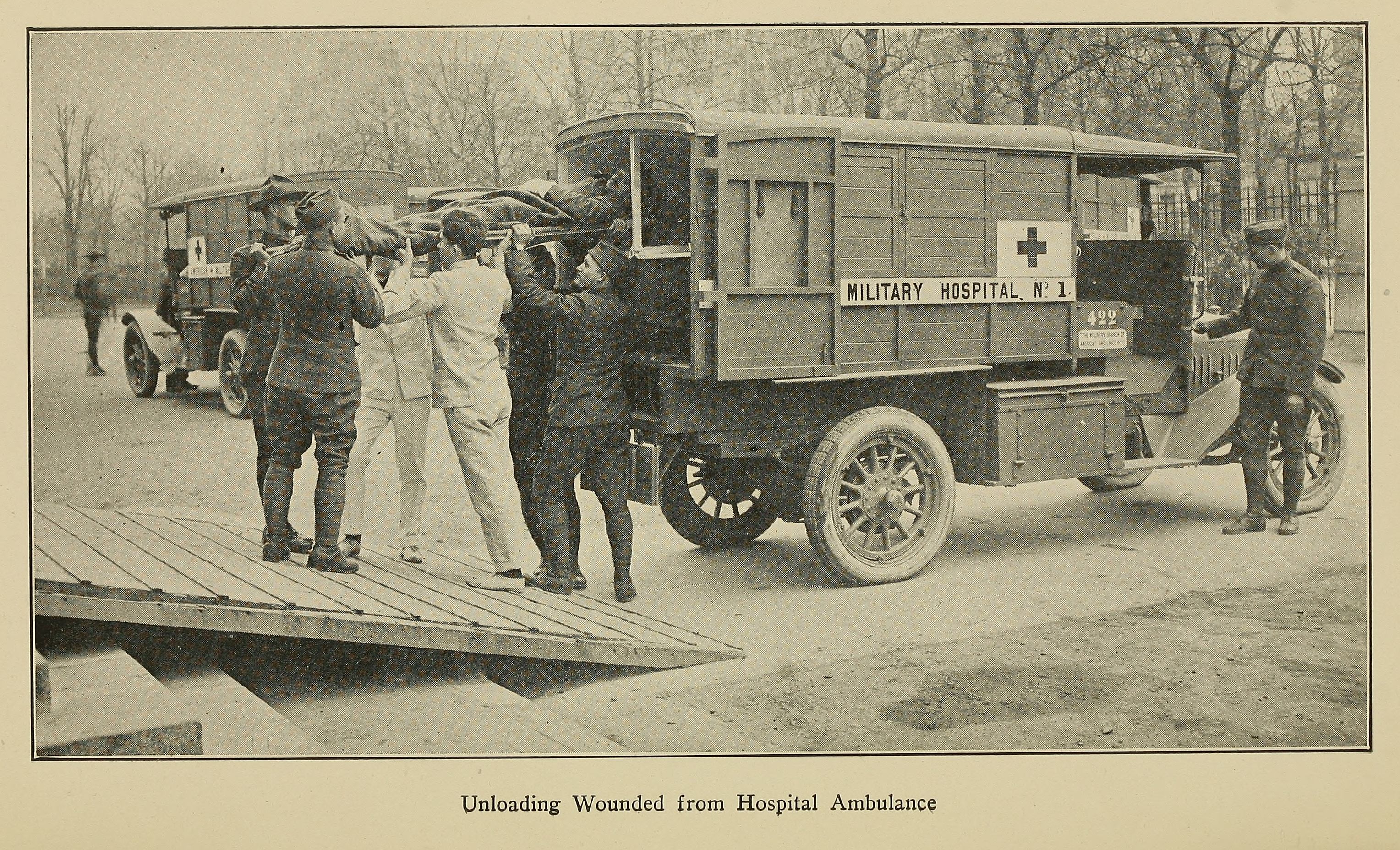 “Unloading Wounded from Hospital Ambulance.” Illustration from American Military Hospital No. 1, formerly American Ambulance Hospital of Paris (1918).